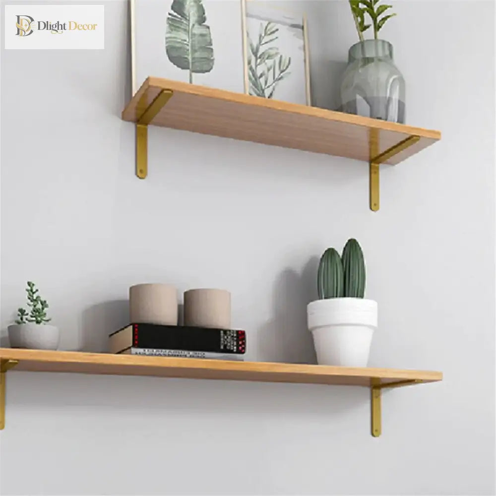Gold L-shaped shelf brackets holding two wood shelves with visible mounting points