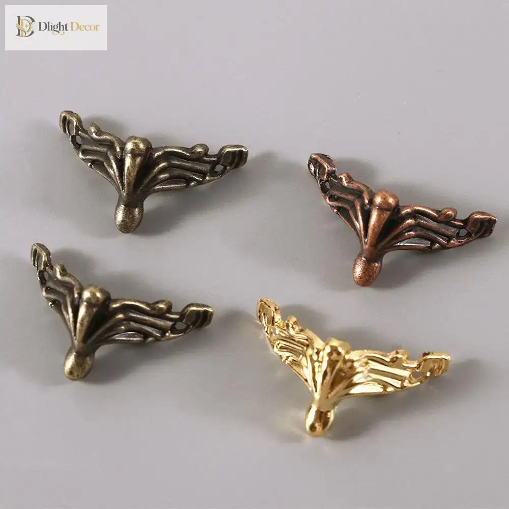 Decorative corner feet set in bronze tones, ornate fan design with curved tips