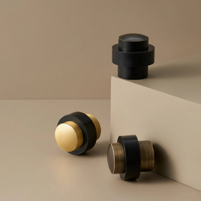 Round door stop with black top and base, gold ring accents