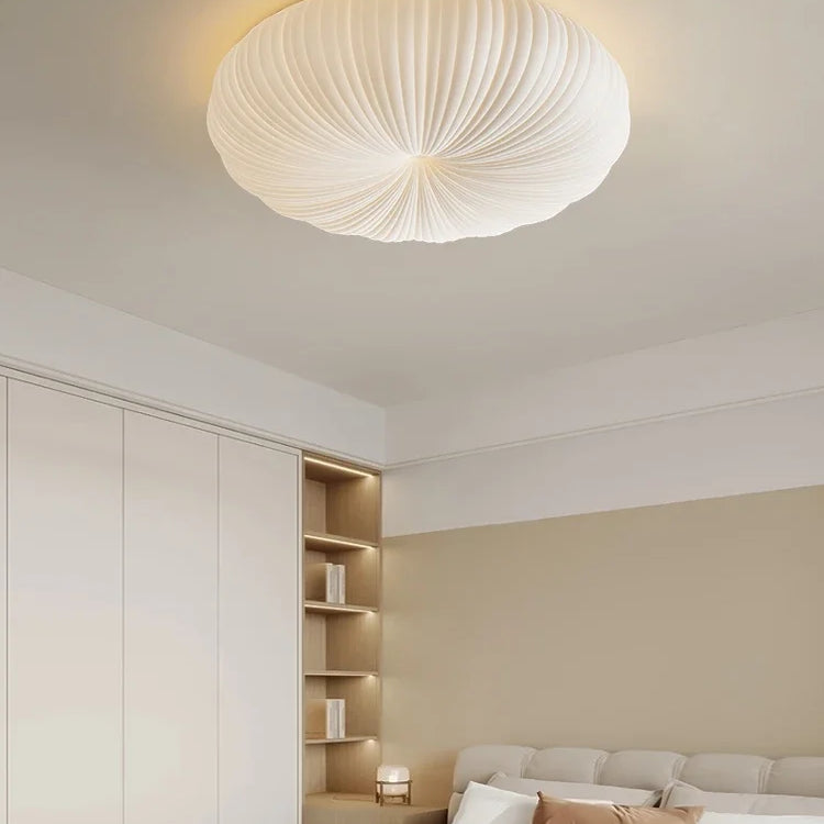 Cream fabric dome ceiling light with ribbed texture in a modern bedroom