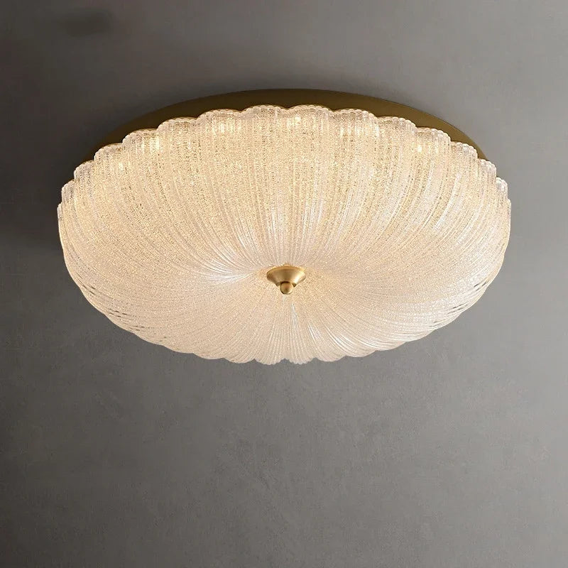 Cream crystal-style acrylic LED flush-mount ceiling light with scalloped diffuser and brass cap