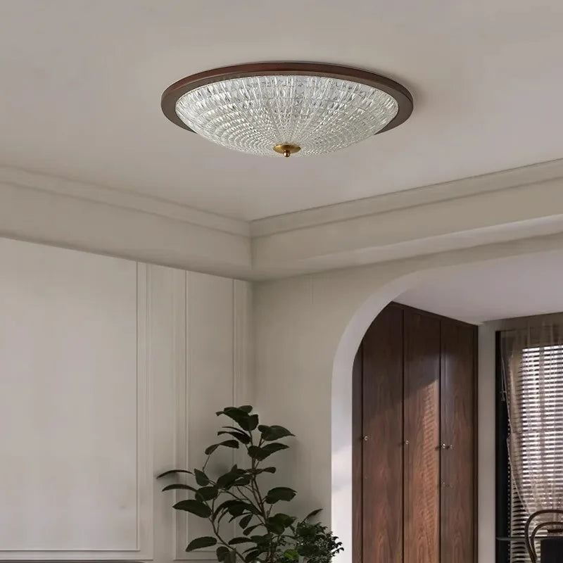 Walnut round flush-mount ceiling light with clear ribbed acrylic diffuser on white ceiling