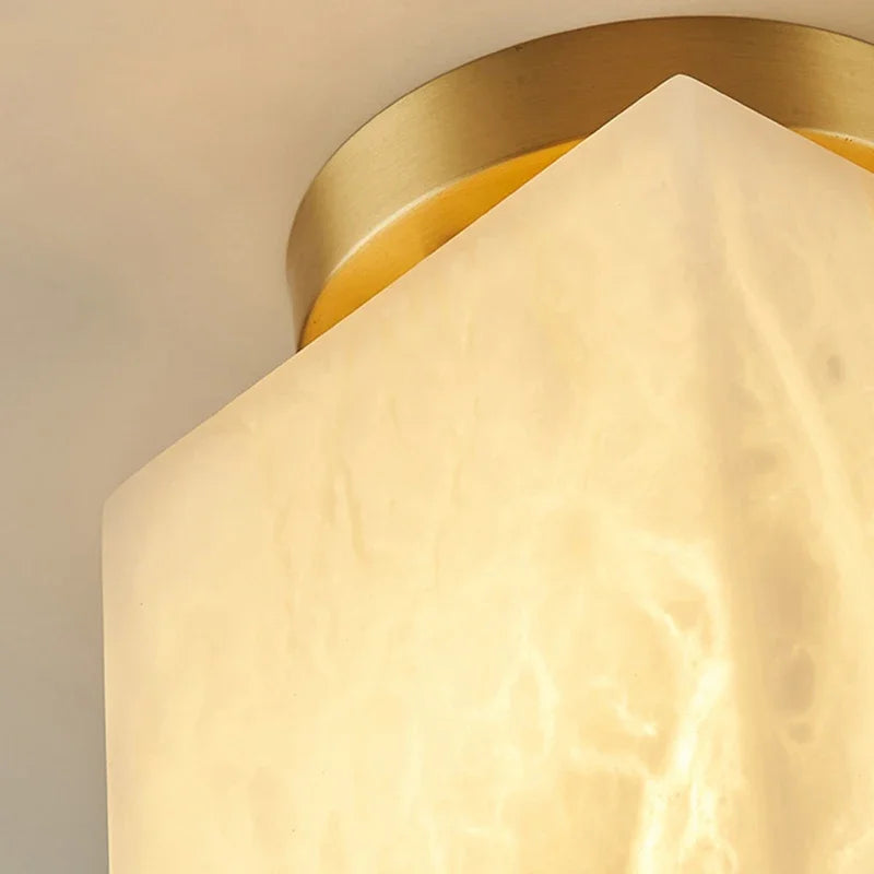 Close-up of gold copper art deco LED ceiling light with marble-pattern shade