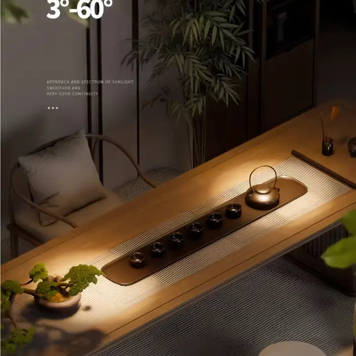Adjustable LED zoom spotlight projecting a warm beam onto a sofa and rug in a room