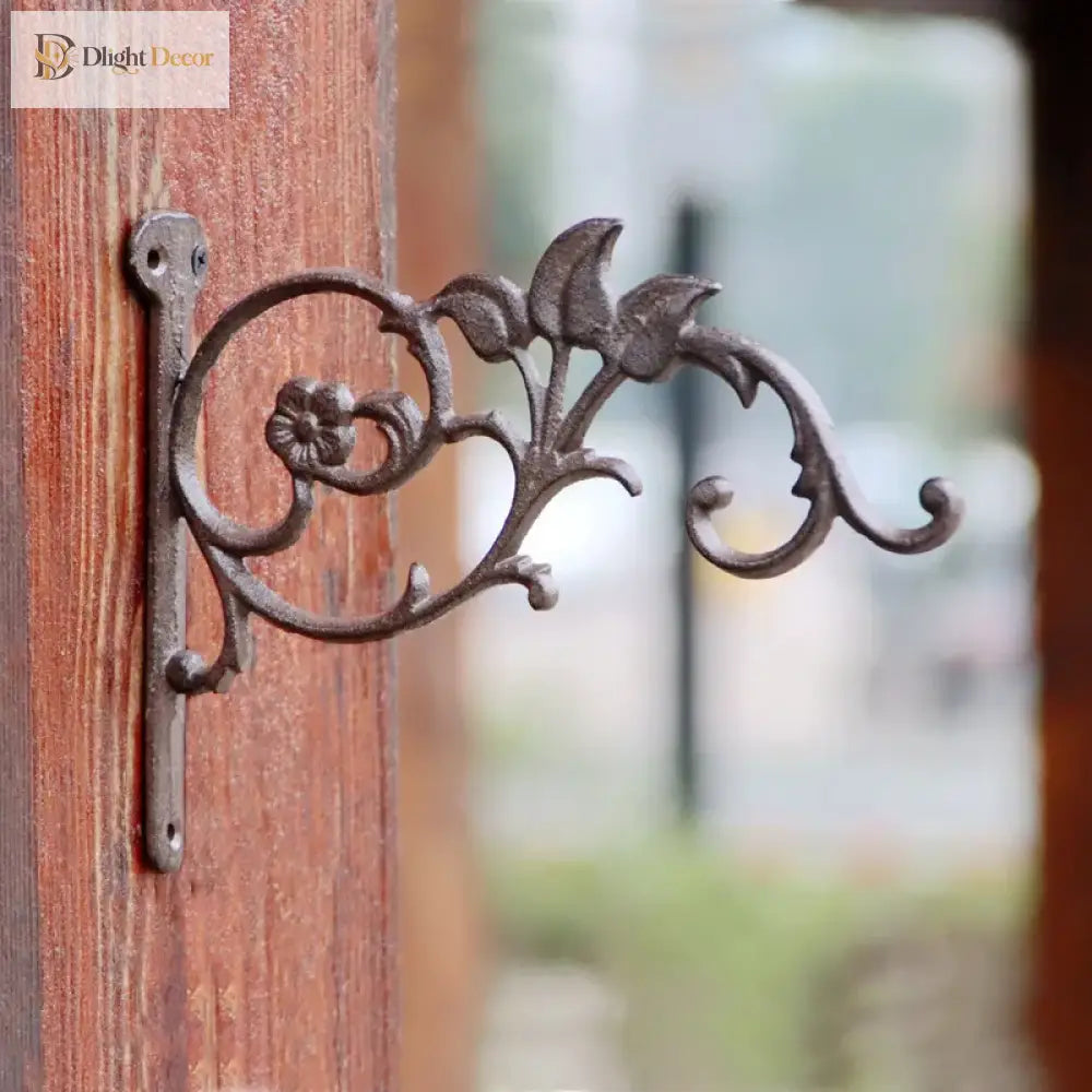 Cast iron wall shelf bracket with circular floral medallion and curled leaf scrolls