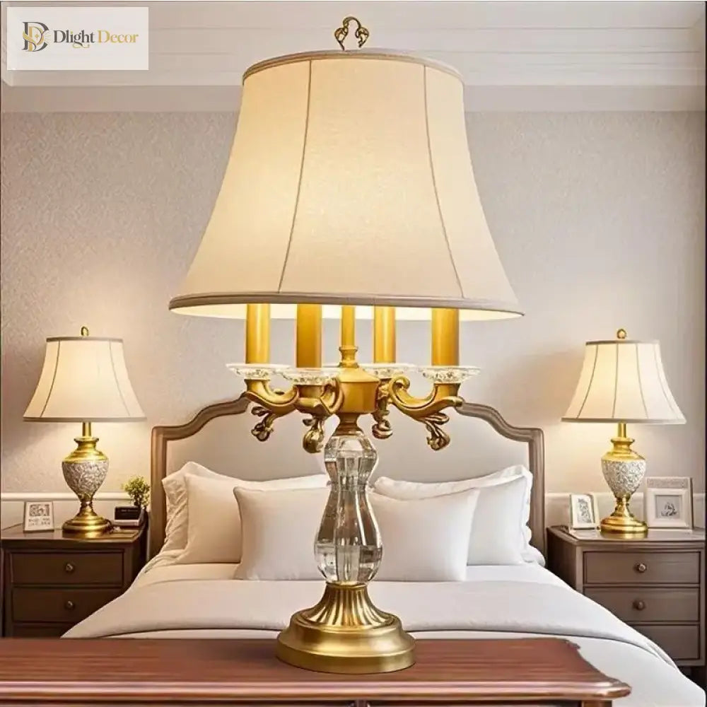 Gold art deco crystal table lamp with pleated cream shade and ornate candle-arm frame