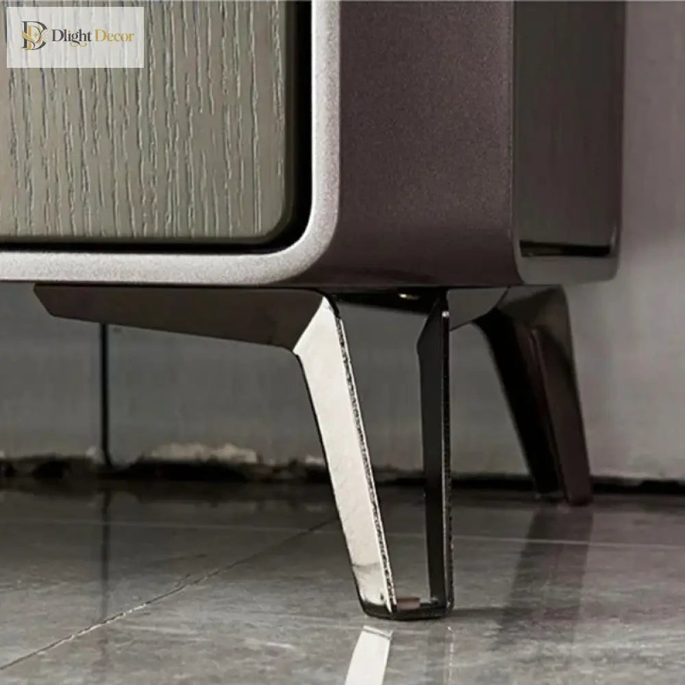 Silvery metal furniture leg with angular base and bracket, mounted under a cabinet
