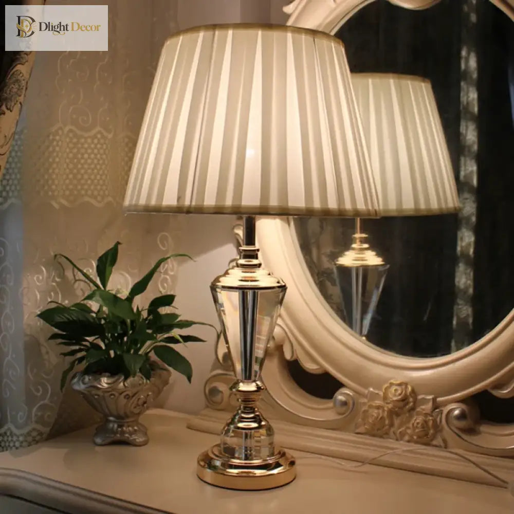 Crystal LED desk lamp on console with gold stand and pleated white drum shade
