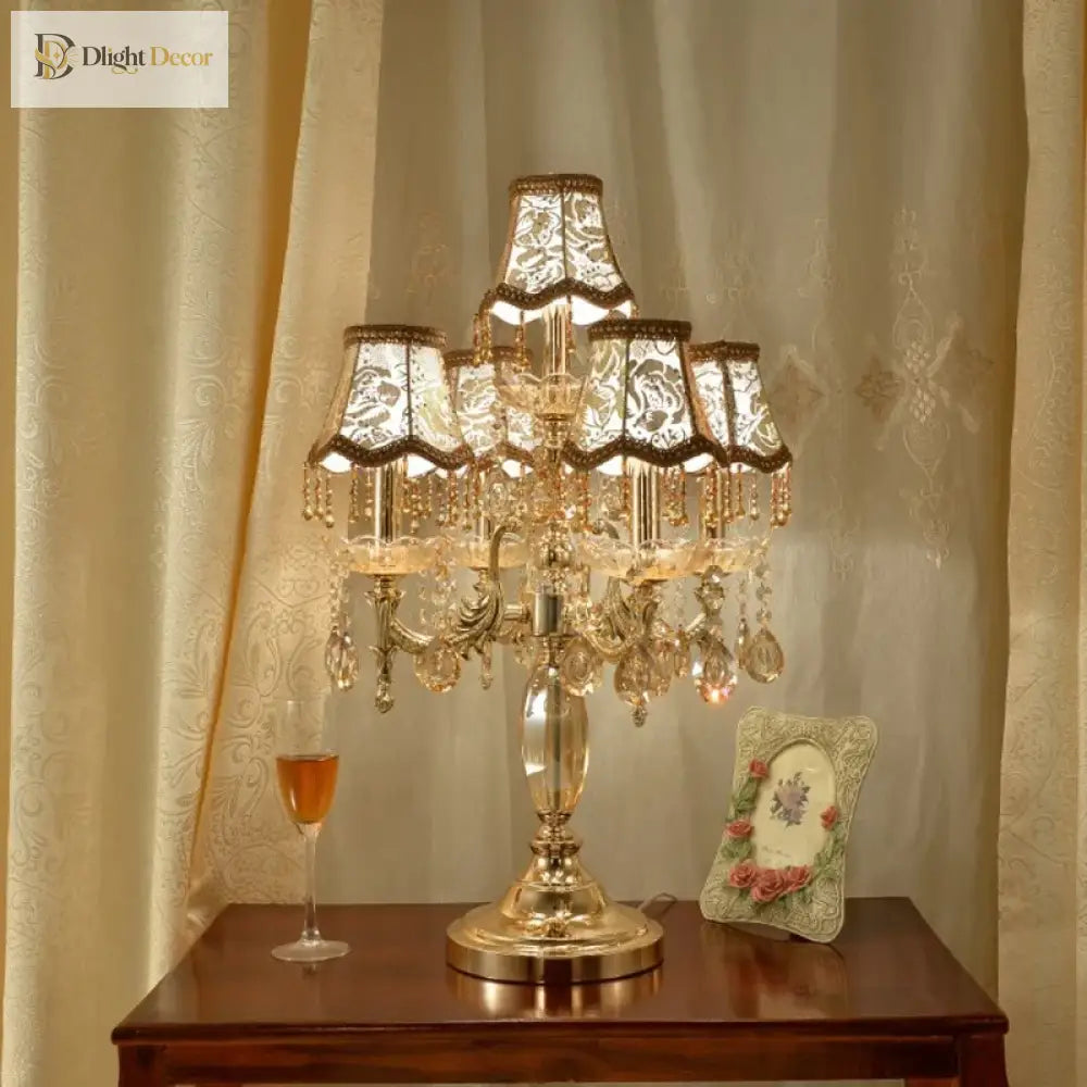 Gold crystal LED desk lamp with chandelier shades and dangling crystal drops on tabletop