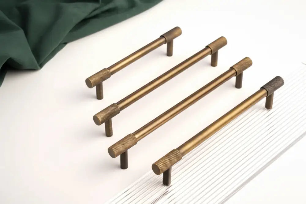 Antique brass cabinet pulls with cross-knurled grip, long bar style, pair shown