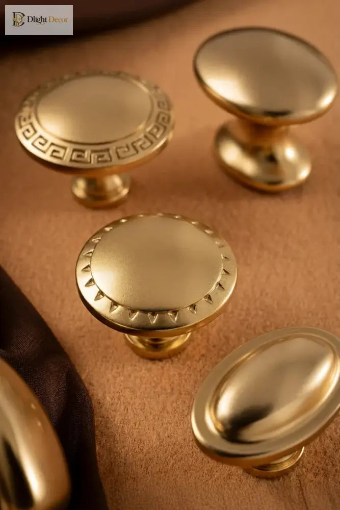Antique brass cabinet knobs with decorative rim bases and mushroom-style round tops