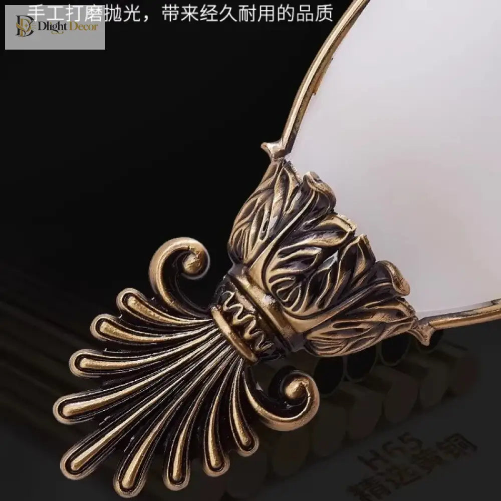 Decorative gold metal leaf and scroll detail for vintage wall sconce