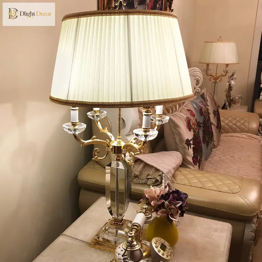 Fabric LED table lamp with pleated cream shade and ornate gold multi-arm candelabra base