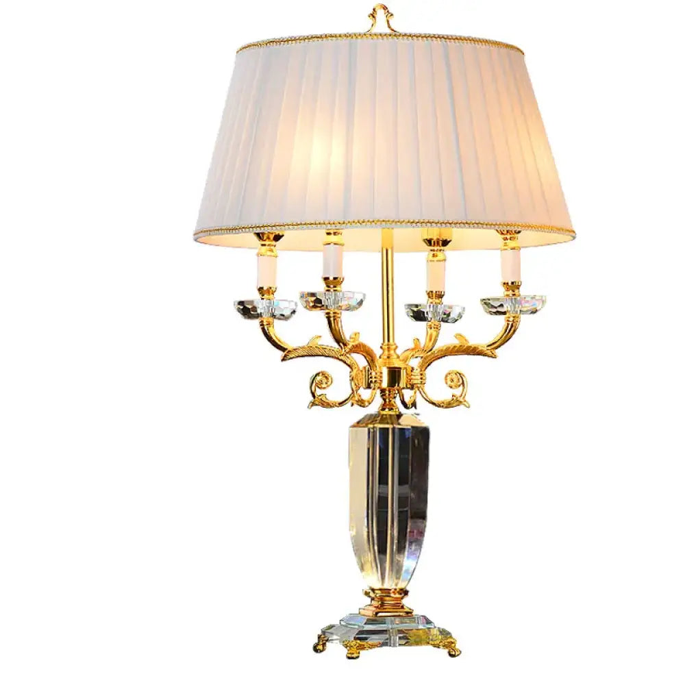Fabric LED table lamp with pleated cream shade and ornate gold base with clear crystal accents