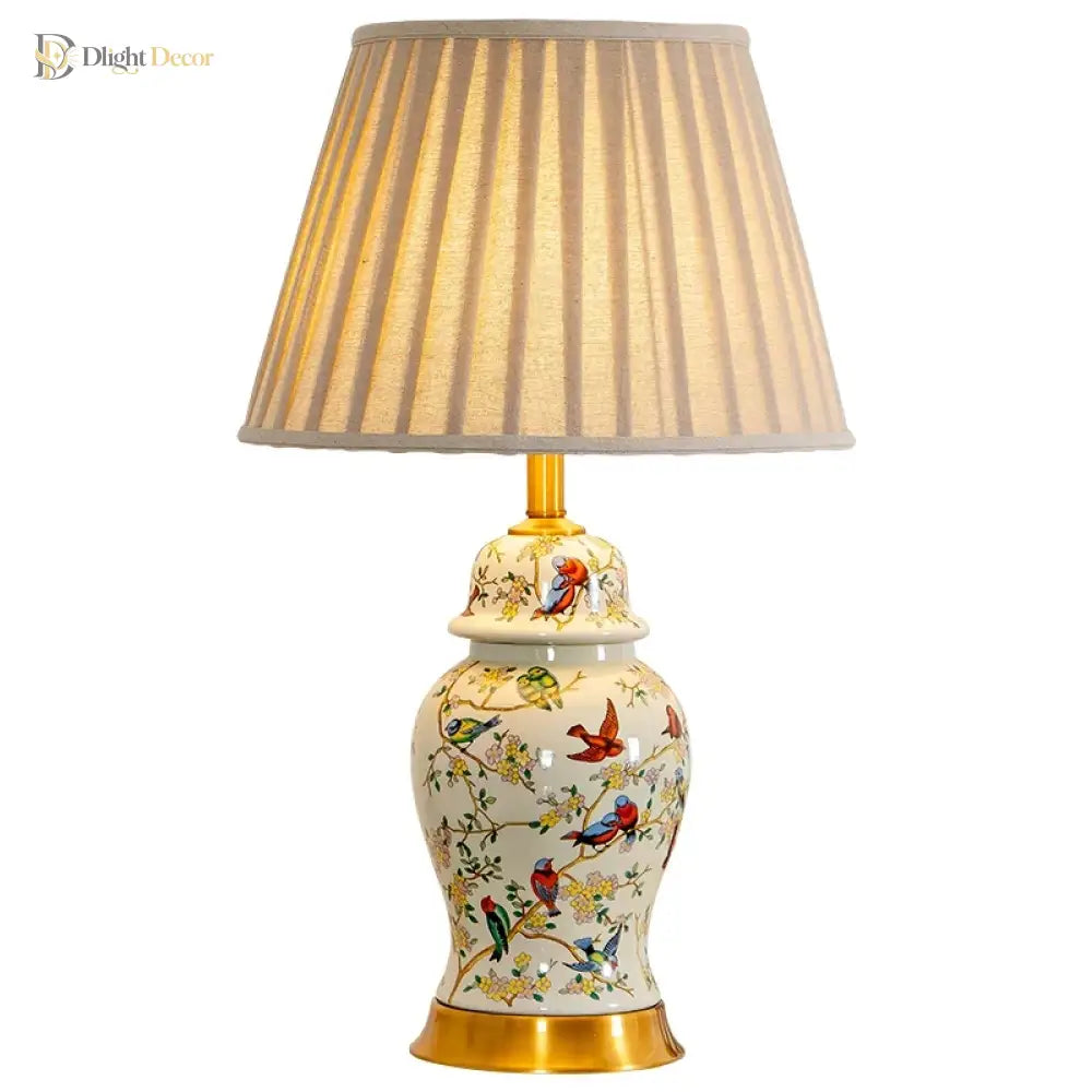 Floral ceramic desk lamp with gold base and pleated fabric shade, centered frontal view.