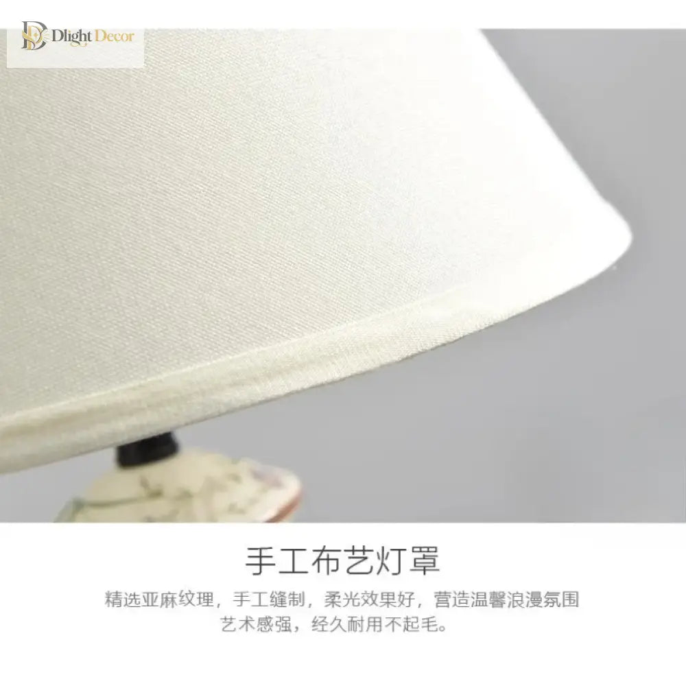 White fabric lamp shade edge with ceramic base partially visible