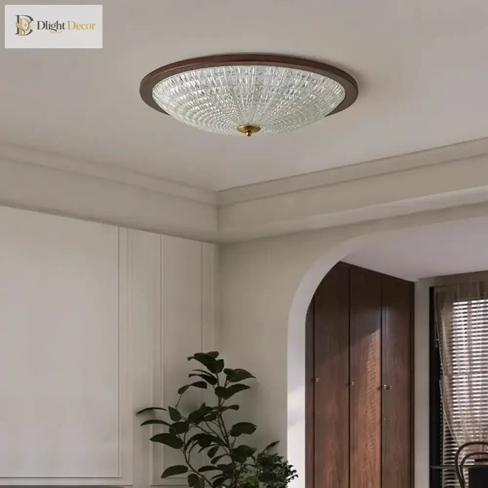 Walnut round flush-mount ceiling light with clear ribbed acrylic diffuser on white ceiling