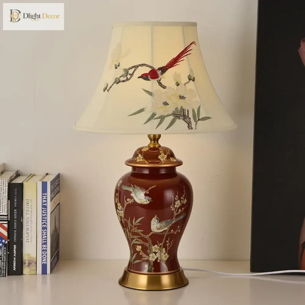 Ceramic LED desk lamp with cream shade featuring bird-and-bamboo design on a red gold base