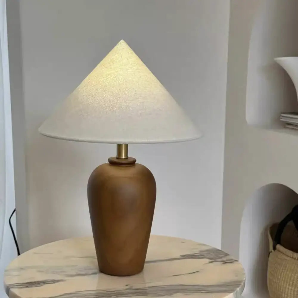 Wooden desk lamp with white cone shade and brass neck on round marble base