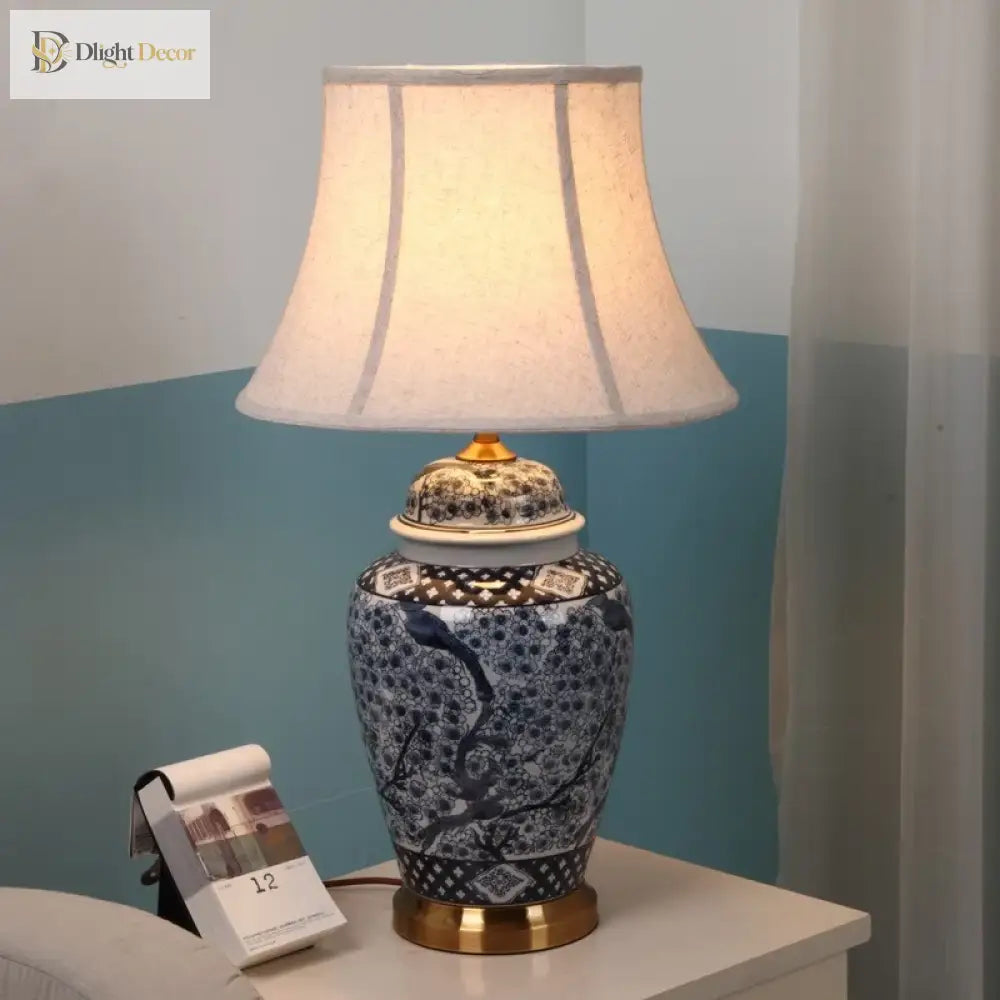 Indigo ceramic floor lamp with beige fabric drum shade and gold top and base