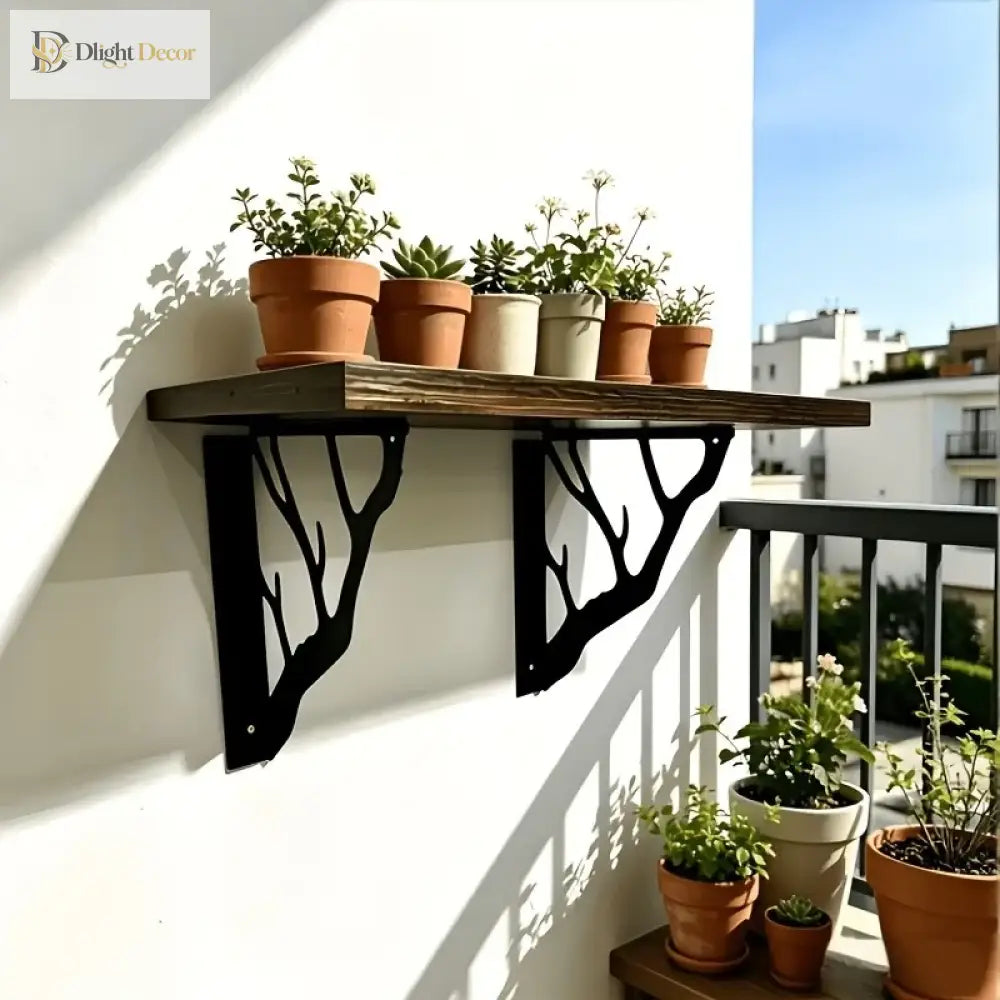 Black metal tree-branch wall brackets supporting a wooden plant shelf outdoors