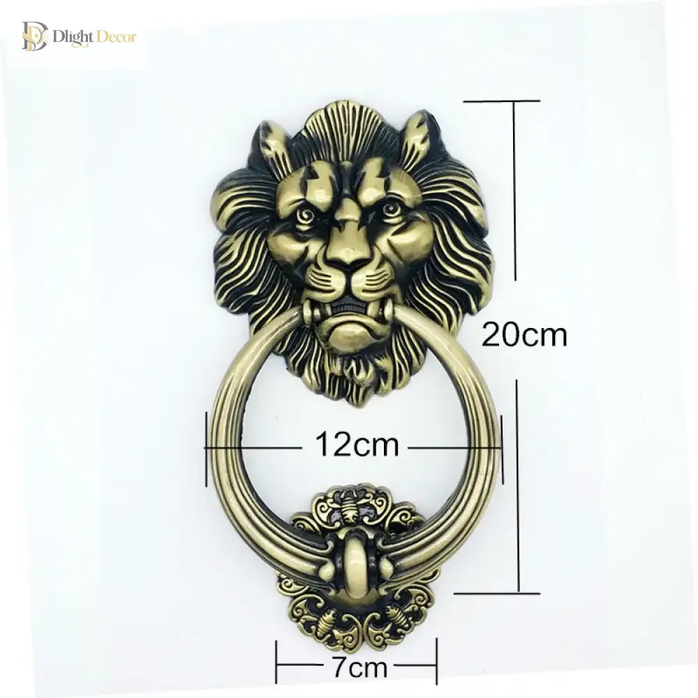 Lion head door knocker with curved ring and ornate base, gold-tone metal