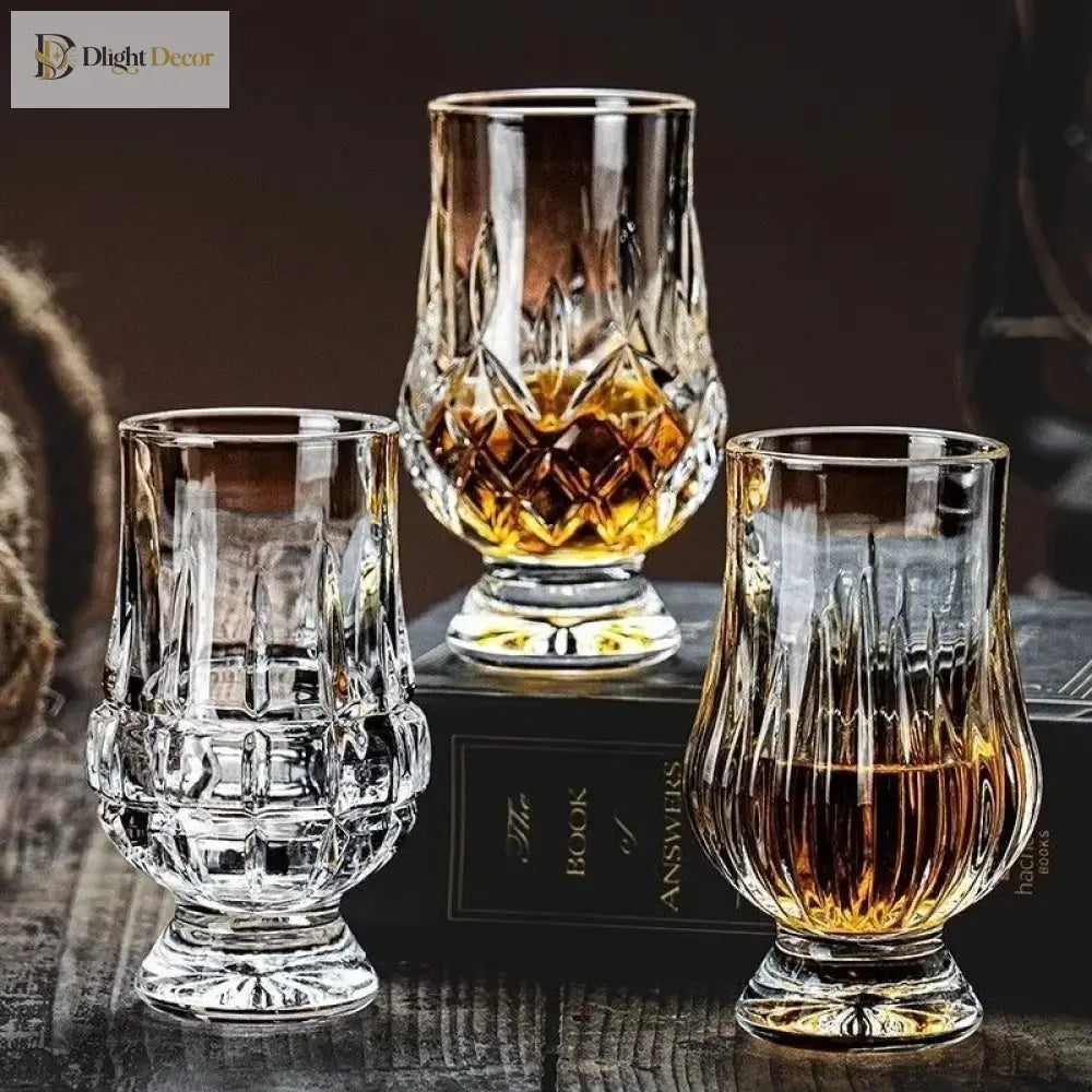 Set of three faceted crystal whiskey tasting glasses with clear stems and star-cut bowls