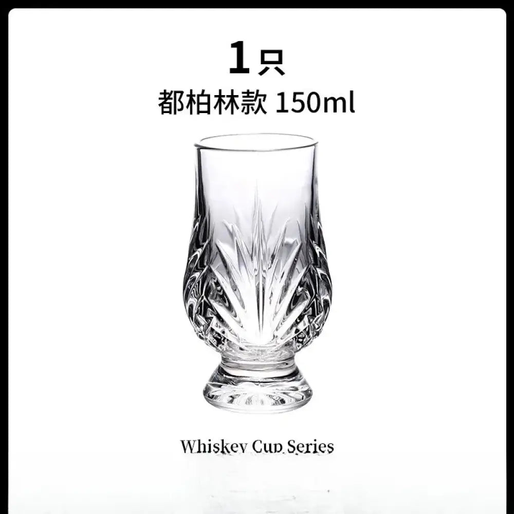 Clear faceted crystal whiskey tasting glass with bold diamond cuts and flared base