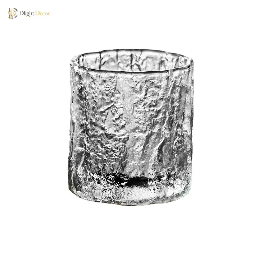 Hammered crystal whiskey rocks glass, cylindrical with textured icy-silver look.