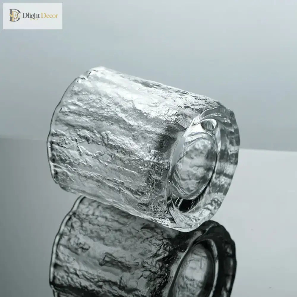 Hammered crystal rocks glass with faceted textured sides and clear rim.