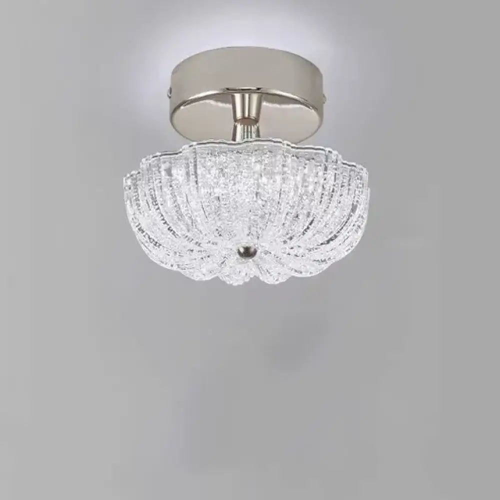 Chrome flush-mount ceiling light with clear crystal-style acrylic drum shade