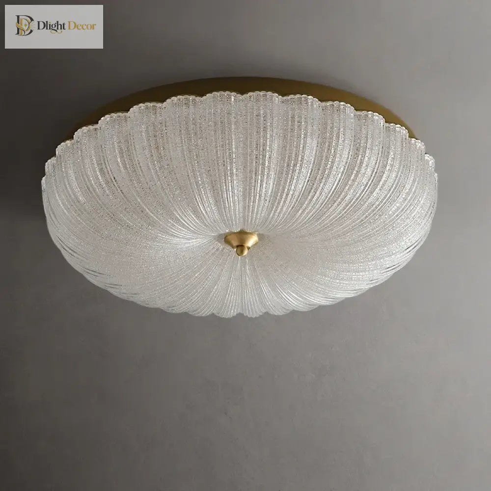 White crystal-style acrylic LED flush-mount ceiling light with scalloped diffuser and brass cap