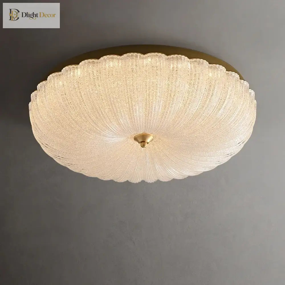Cream crystal-style acrylic LED flush-mount ceiling light with scalloped diffuser and brass cap