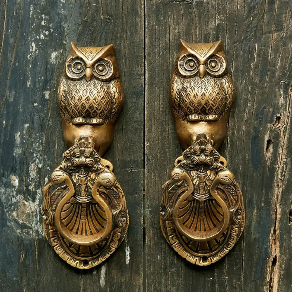 Victorian cast brass owl door knocker with detailed etched wings and ornate curly base