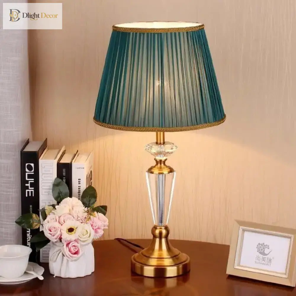 Gold and clear crystal LED table lamp with pleated teal fabric shade and pedestal base
