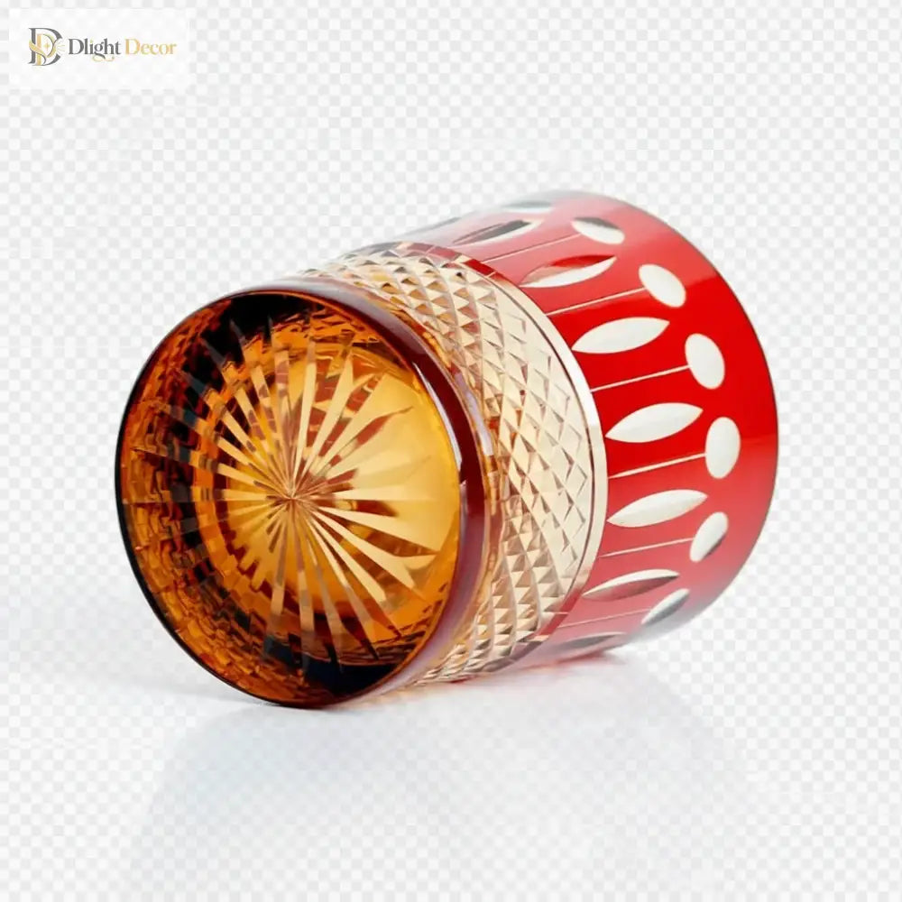 Red diamond-cut crystal whiskey glass with gold-toned faceted side pattern