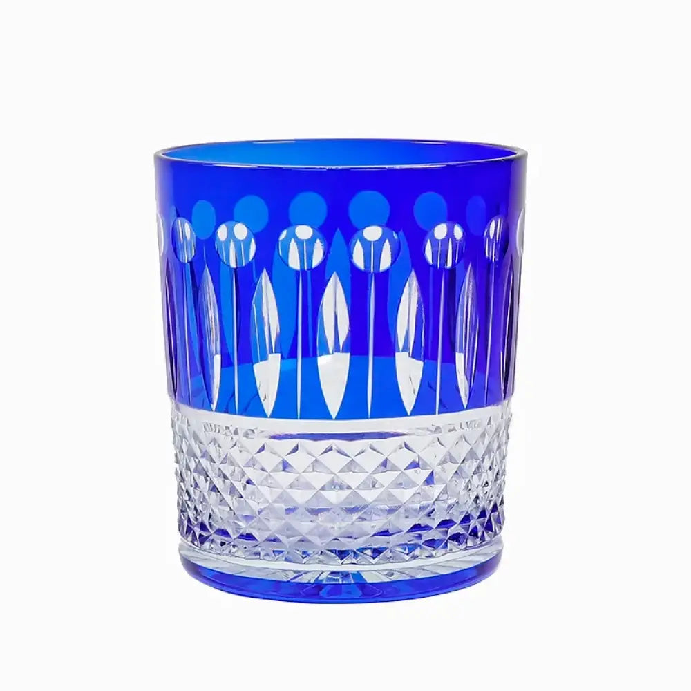 Blue and clear diamond-cut crystal whiskey tumbler with faceted pattern and base