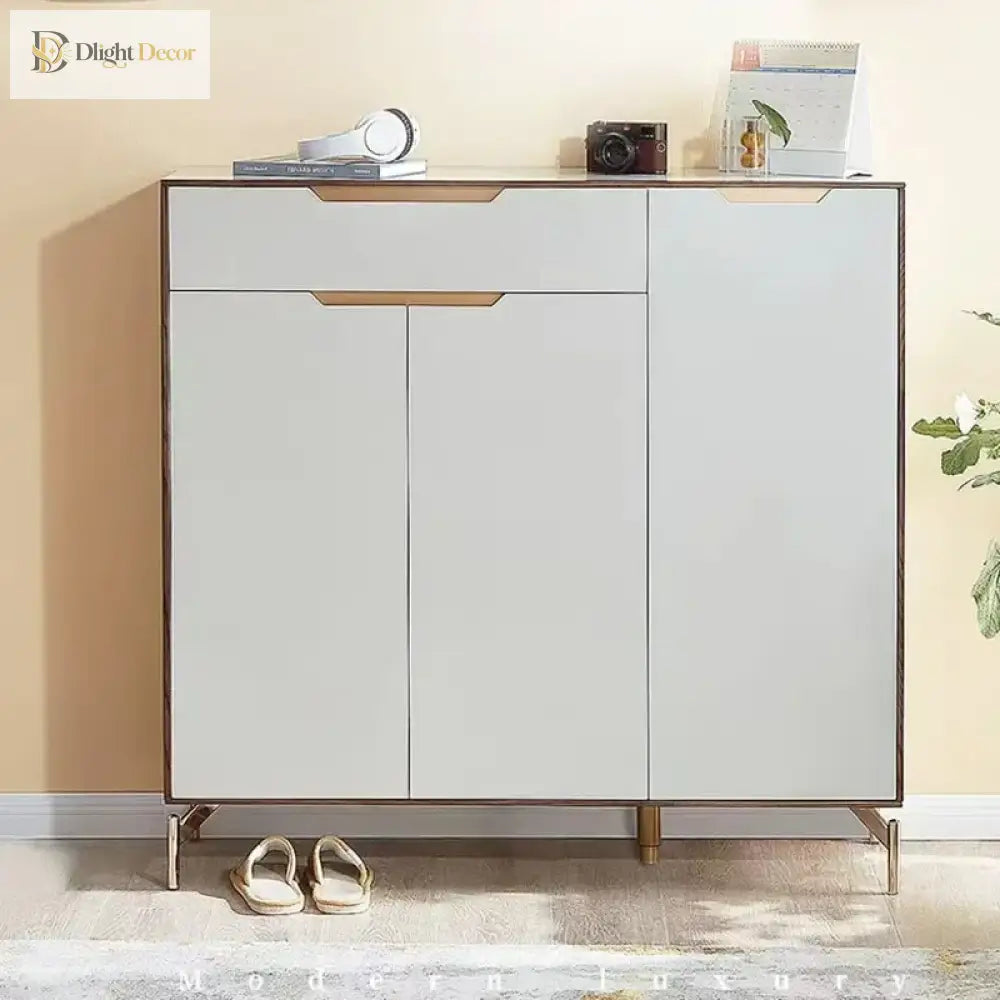 Gold stainless steel legs beneath a white cabinet with door panels