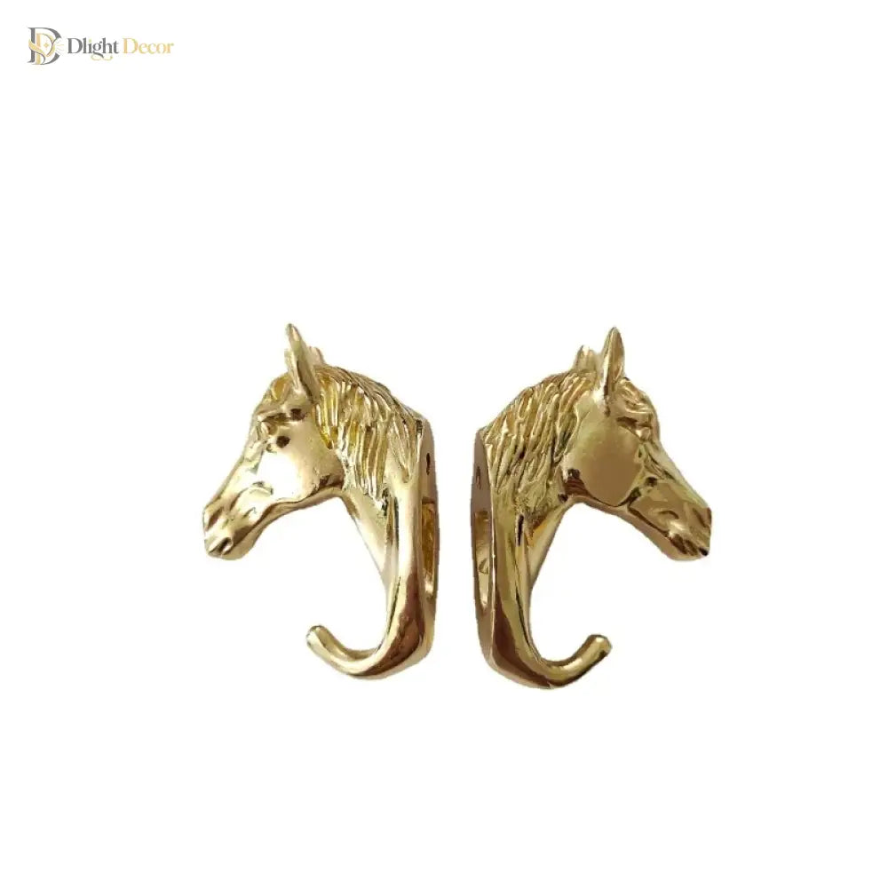 Solid brass horse head cabinet knob pair, front view with curved hook ends