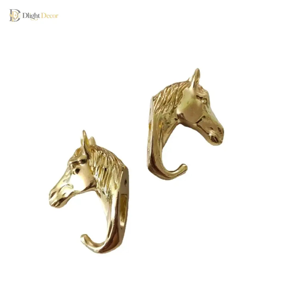 Solid brass horse head cabinet knob pair, close-up with curved hook fronts
