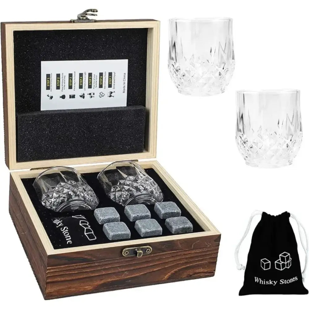 Granite whiskey chilling rocks set in wooden box with two faceted glasses and cubes