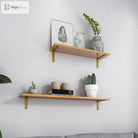 Gold L-shaped shelf brackets supporting a wood wall shelf in a home display