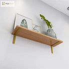 Gold L-shaped shelf brackets mounted under a wood shelf for wall storage