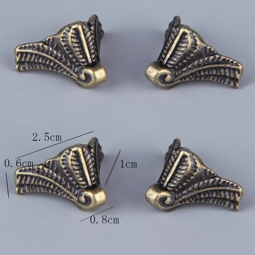 Bronze corner feet shown with dimensions, ornate scroll pattern on corner protectors