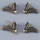 Bronze corner feet shown with dimensions, ornate scroll pattern on corner protectors