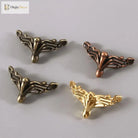 Decorative corner feet set in bronze tones, ornate fan design with curved tips