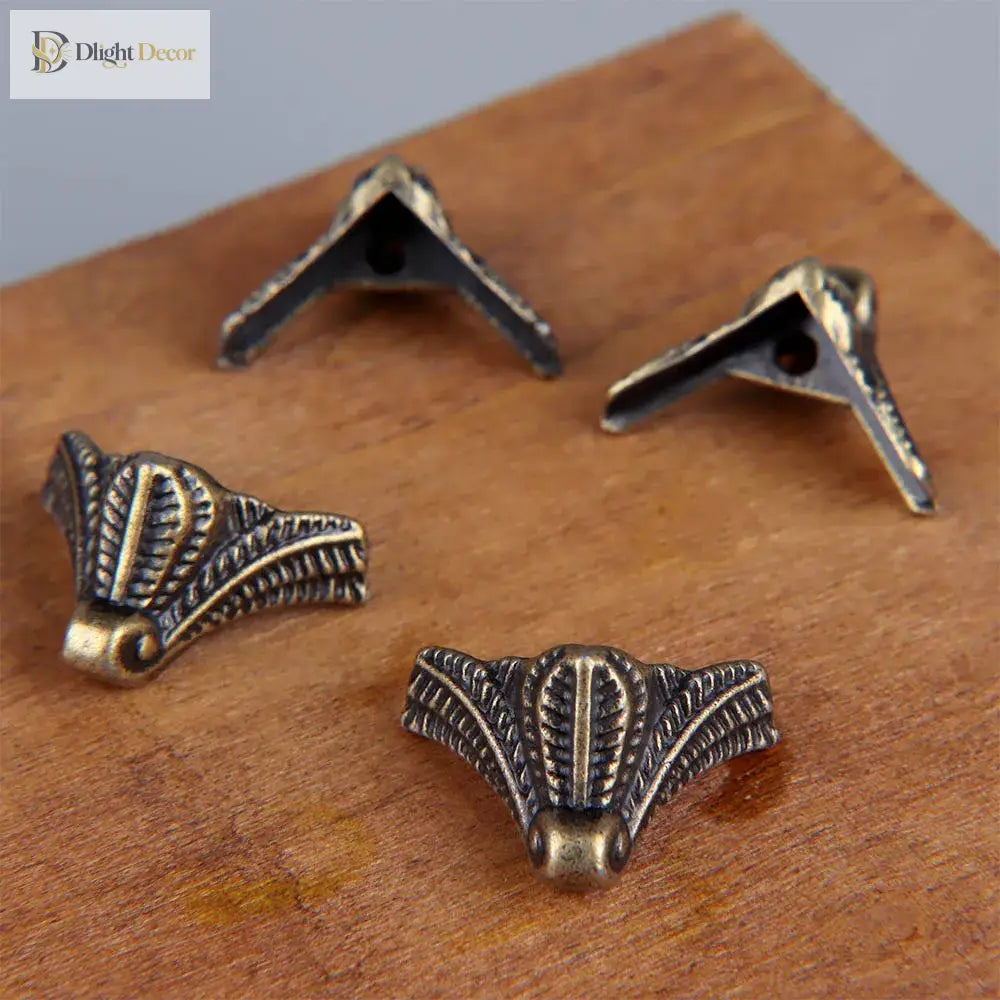 Set of bronze corner feet with triangular mounts and carved decorative edges