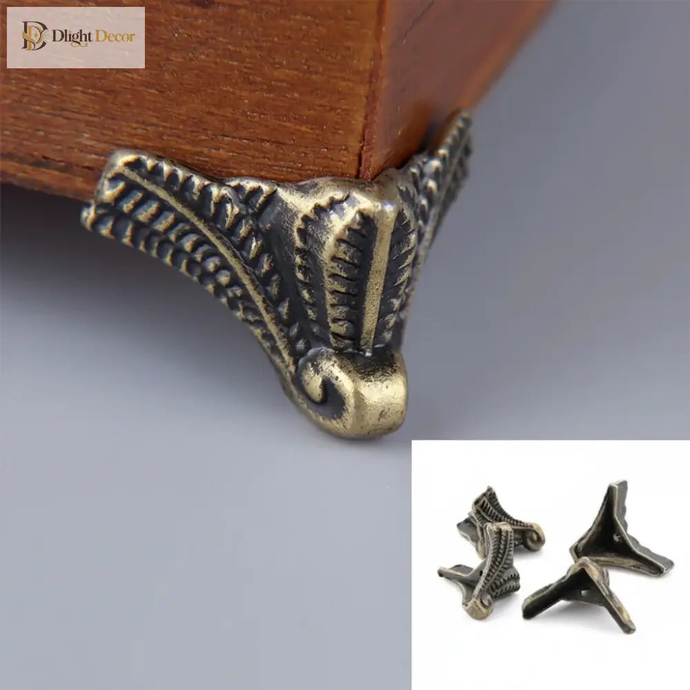 Antique bronze box corner foot, ornate scroll design with small mounting base