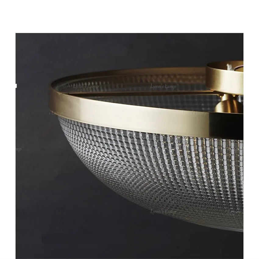 Flush-mount ceiling light side view: clear faceted glass bowl with gold rim