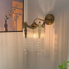 Gold crystal wall sconce with crystal fringe and round backplate, wall mounted